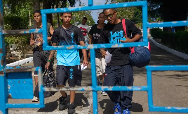 Damian Farinas, right, walks out of La Lima penitentiary alongside other pardoned prisoners after their release in Guanabo, Cuba, Friday, April 3, 2026. (AP Photo/Ramon Espinosa)
