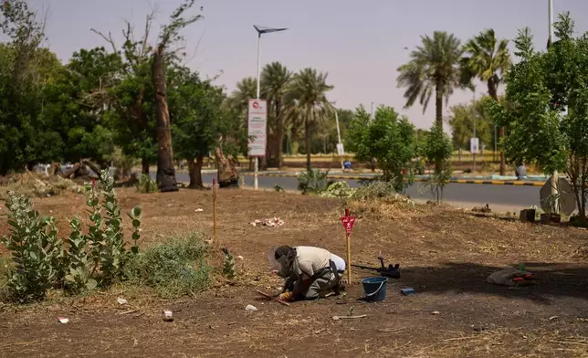 A member of Jasmar's demining team works in a mine-affected area in Khartoum, Sudan, Tuesday, April 21, 2026. (AP Photo/Bernat Armangue)
