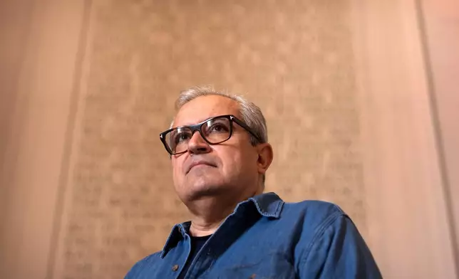 Iranian expatriate Nik Kowsar poses for a photograph at the Lincoln Memorial, March 31, 2026, in Washington. (AP Photo/Mark Schiefelbein)