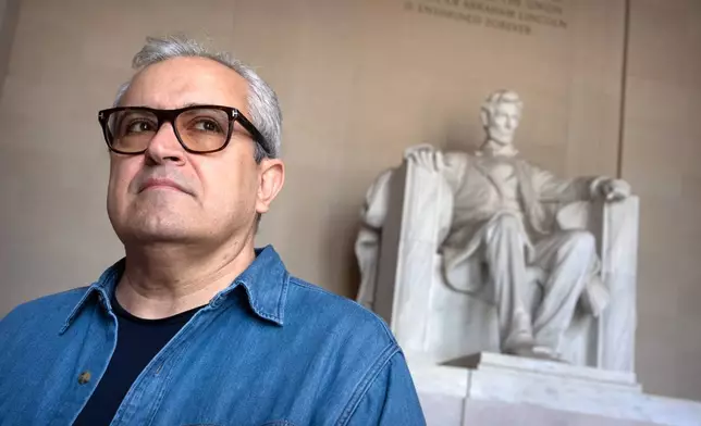 Iranian expatriate Nik Kowsar poses for a photograph at the Lincoln Memorial, March 31, 2026, in Washington. (AP Photo/Mark Schiefelbein)