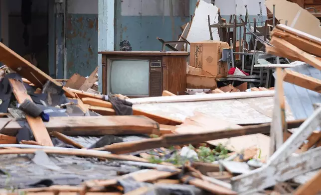 A television is surrounded by debris in a storm-damaged home in Mineral Wells, Texas, Wednesday, April 29, 2026. (AP Photo/Julio Cortez)