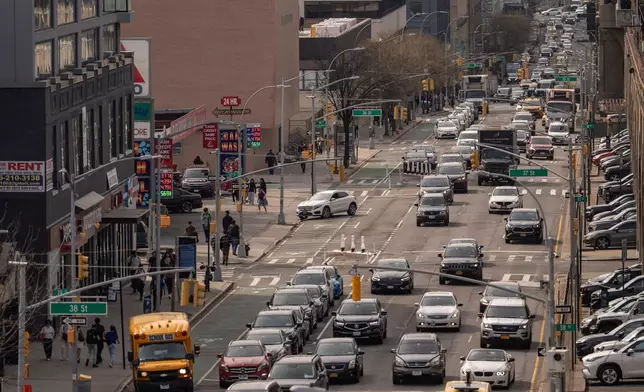 Vehicles drive past a CITGO gas station in the Queens borough of New York, Tuesday, March 31, 2026. (AP Photo/Yuki Iwamura)