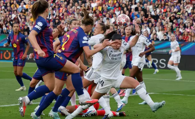 Barcelona's Irene Paredes heads the ball to score her side's third goal during a Champions League quarterfinal soccer match between Barcelona and Real Madrid, in Barcelona, Spain, Thursday, April 2 2026. (AP Photo/Joan Monfort)