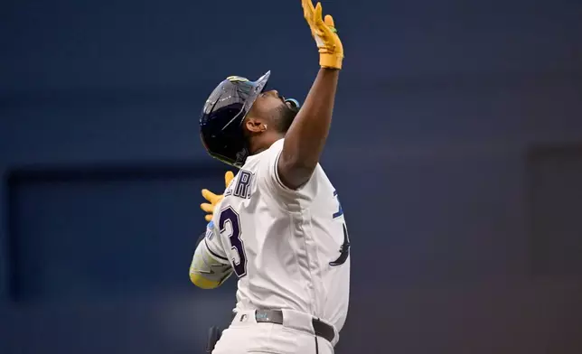 Tampa Bay Rays' Junior Caminero celebrates after his solo home run during the first inning of a baseball game against the Minnesota Twins, Friday, April 24, 2026, in St. Petersburg, Fla. (AP Photo/Jason Behnken)