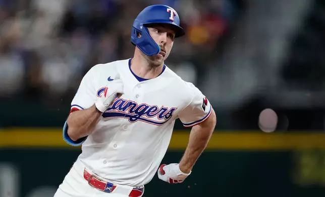 Texas Rangers' Evan Carter rounds the bases on his way home after hitting a two-run inside the park home run in the third inning of a baseball game against the Pittsburgh Pirates Thursday, April 23, 2026, in Arlington, Texas. (AP Photo/Tony Gutierrez)
