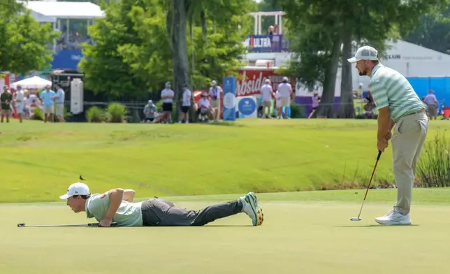 Matt Fitzpatrick, left, of England, lines up a putt with his brother Alex Fitzpatrick, right, at the ninth hole during the final round of the PGA Zurich Classic of New Orleans golf tournament, Sunday, April 26, 2026, in Avondale, La. (AP Photo/Matthew Hinton)