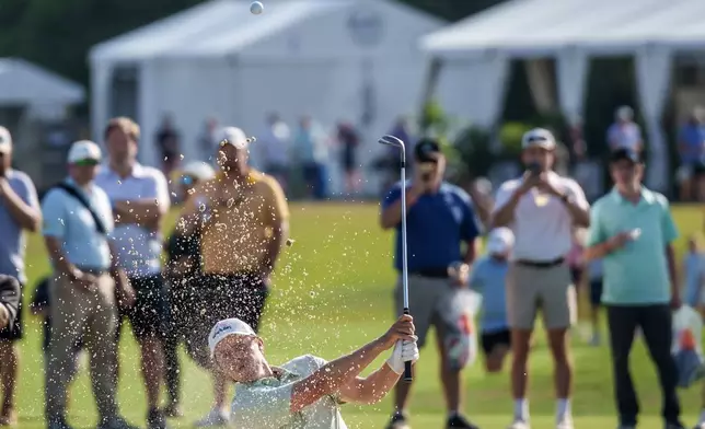 Matt Fitzpatrick, of England, hits a bunker shot close to the 18th hole to set up a birdie putt by his brother Alex Fitzpatrick and winning the final round of the PGA Zurich Classic of New Orleans golf tournament, Sunday, April 26, 2026, in Avondale, La. (AP Photo/Matthew Hinton)