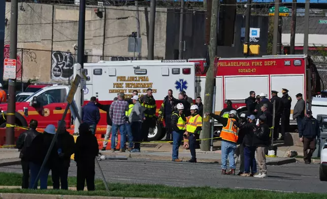 First responders gather near a partially collapsed parking garage in Philadelphia, Thursday, April 9, 2026. (AP Photo/Matt Rourke)
