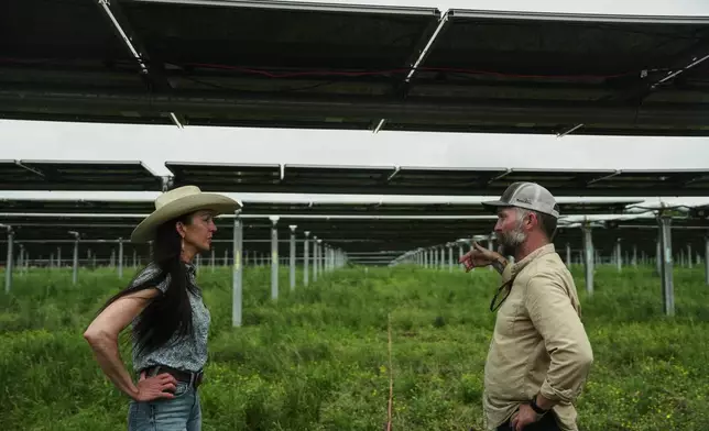 Anna Clare Monlezun, left, a rangeland scientist, chats with Loran Shallenberger, right, vice president of regenerative energy and agrivoltaics at Silicon Ranch, Tuesday, April 28, 2026, in Christiana, Tenn. (AP Photo/Joshua A. Bickel)