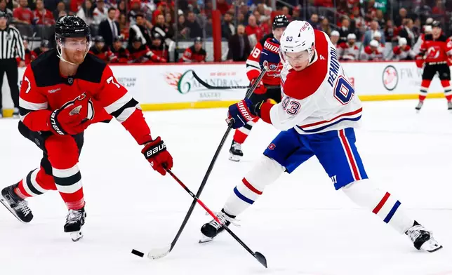 Montréal Canadiens right wing Ivan Demidov (93) shoots against New Jersey Devils defenseman Dougie Hamilton (7) during the first period of an NHL hockey game, Saturday, April 4, 2026, in Newark, N.J. (AP Photo/Noah K. Murray)