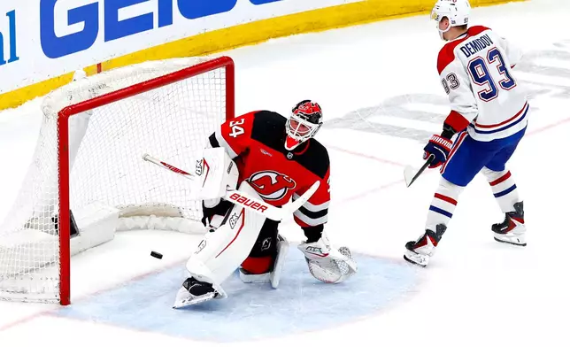 Montréal Canadiens right wing Ivan Demidov (93) scores against New Jersey Devils goaltender Jake Allen (34) during a shootout in an NHL hockey game, Saturday, April 4, 2026, in Newark, N.J. (AP Photo/Noah K. Murray)