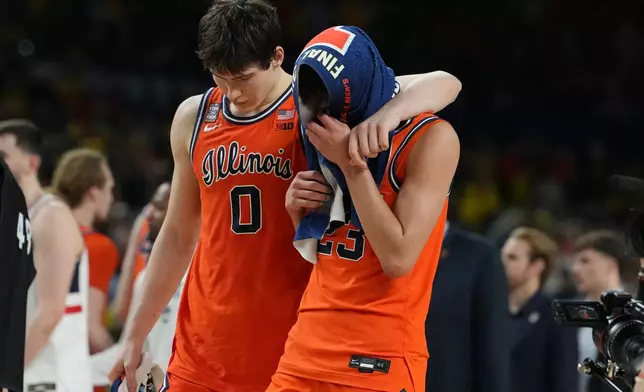 Illinois' David Mirkovic (0) and Keaton Wagler reacts after losing to UConn in an NCAA college basketball tournament semifinal game at the Final Four, Saturday, April 4, 2026, in Indianapolis. (AP Photo/Michael Conroy)