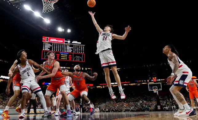 UConn guard Braylon Mullins (24) rebounds against Illinois during the second half of an NCAA college basketball tournament semifinal game at the Final Four, Saturday, April 4, 2026, in Indianapolis. (AP Photo/Abbie Parr)