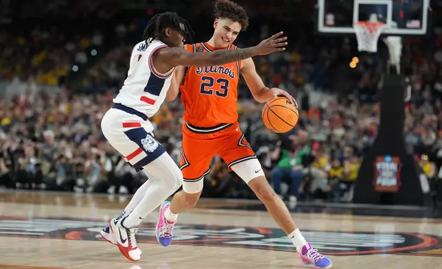 Illinois' Keaton Wagler (23) drives around UConn's Malachi Smith during the second half of an NCAA college basketball tournament semifinal game at the Final Four, Saturday, April 4, 2026, in Indianapolis. (AP Photo/Michael Conroy)