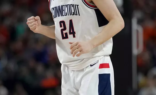 UConn guard Braylon Mullins (24) celebrates a basket against Illinois during the second half of an NCAA college basketball tournament semifinal game at the Final Four, Saturday, April 4, 2026, in Indianapolis. (AP Photo/Abbie Parr)