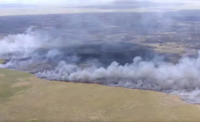 This image taken from a WSVN video a wildfire burning Wednesday, April 22, 2026, in Broward County, Fla. (WSVN/ABC Miami via AP)