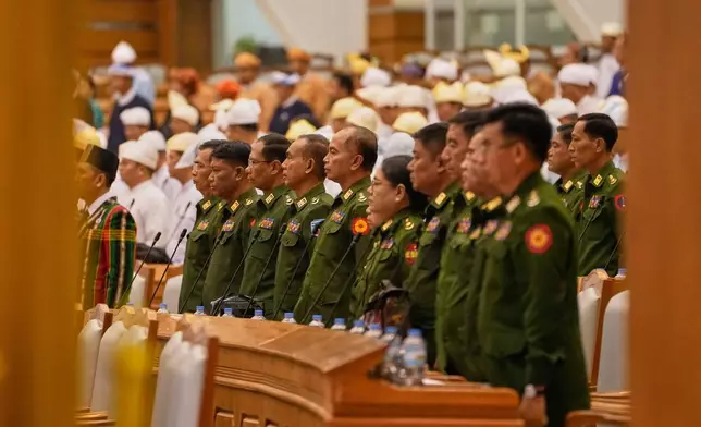 Myanmar's military representatives stay stand as Parliament chairman Aung Lin Dwe, unseen, leaves after a session at Union Parliament in Naypyitaw, Myanmar, Thursday, April 9, 2026. (AP Photo/Aung Shine Oo)