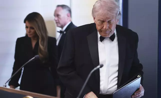 President Donald Trump and first lady Melania Trump, left, arrive at the James Brady Press Briefing Room at the White House after an unspecified threat at the annual White House Correspondents' Association Dinner in Washington, Saturday, April 25, 2026. (AP Photo/Tom Brenner)