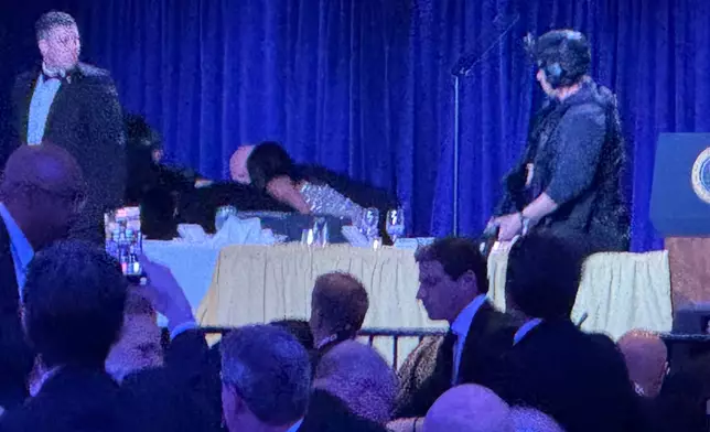 Secret service agents respond during the White House Correspondents Dinner, Saturday, April 25, 2026, in Washington. (AP Photo/Mark Schiefelbein)