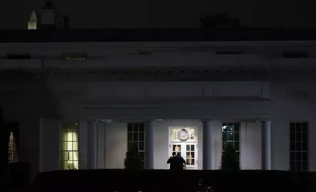 People are seen outside the West Wing driveway entrance of the White House, Saturday, April 25, 2026, in Washington. (AP Photo/Tom Brenner)