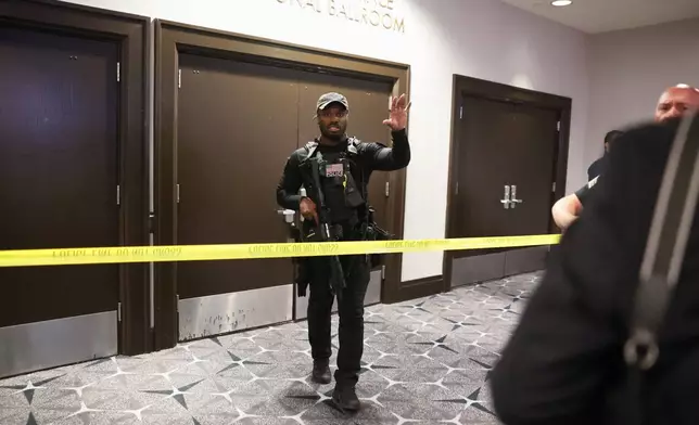 Law enforcement responds to an incident at the White House Correspondents Dinner, Saturday, April 25, 2026, in Washington. (AP Photo/Tom Brenner)