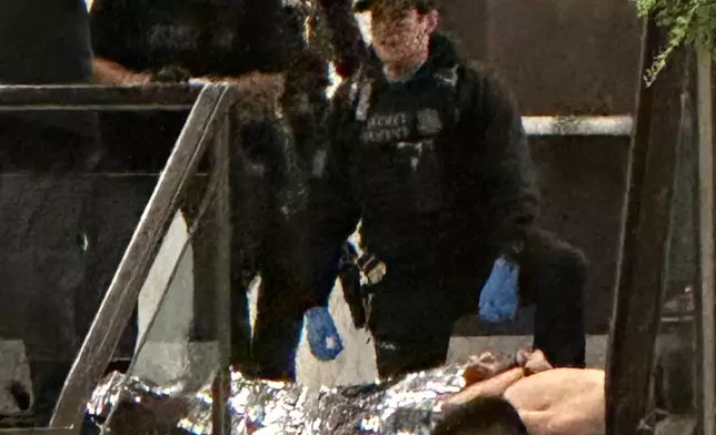 Members of law enforcement control shooting suspect Cole Tomas Allen during the White House Correspondents Dinner, Saturday, April 25, 2026, in Washington. (AP Photo/Alex Brandon)