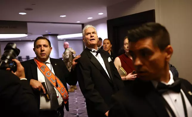 Law enforcement responds during an incident at the White House Correspondents Dinner, Saturday, April 25, 2026, in Washington. (AP Photo/Tom Brenner)