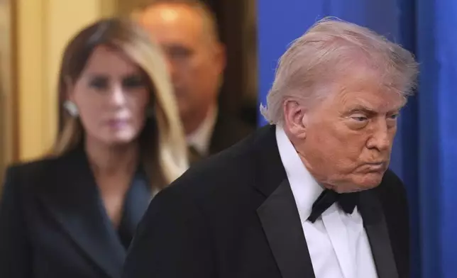 President Donald Trump with first lady Melania Trump, walks in to speak in the James Brady Press Briefing Room at the White House after an unspecified threat at the annual White House Correspondents' Association Dinner in Washington, Saturday, April 25, 2026. (AP Photo/Alex Brandon)
