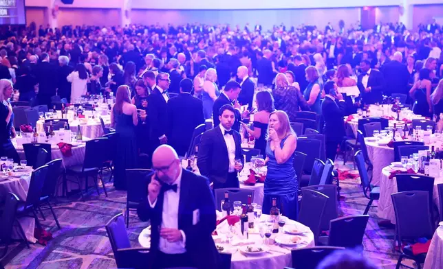Guests begin to exit during the White House Correspondents Dinner, Saturday, April 25, 2026, in Washington. (AP Photo/Tom Brenner)