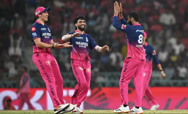 Rajasthan Royals' Ravindra Jadeja, right, celebrates with teammates the wicket of Lucknow Super Giants' Nicholas Pooran during the Indian Premier League cricket match between Lucknow Super Giants and Rajasthan Royals in Lucknow, India, Wednesday, April 22, 2026. (AP Photo)