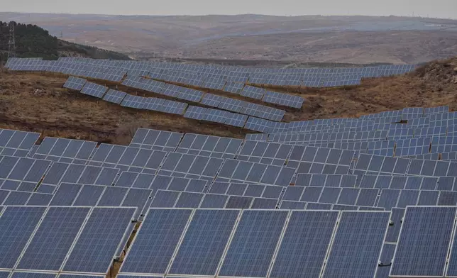 A solar farm operates in Datong, China, Friday, March 13, 2026. (AP Photo/Ng Han Guan)