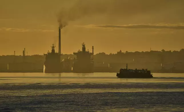 FILE - A ferry crosses Havana Bay past the Nico Lopez oil refinery where tankers are anchored in Havana Bay, Cuba, March 24, 2026. (AP Photo/Ramon Espinosa, File)
