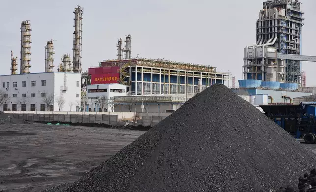 Coal piles sit near a chemical plant in Datong, China, Saturday, March 14, 2026. (AP Photo/Ng Han Guan)
