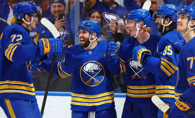 Buffalo Sabres teammates celebrate a goal by defenseman Rasmus Dahlin (26) during the first period in Game 5 of a first-round NHL hockey Stanley Cup playoff series against the Boston Bruins Tuesday, April 28, 2026, in Buffalo, N.Y. (AP Photo/Jeffrey T. Barnes)