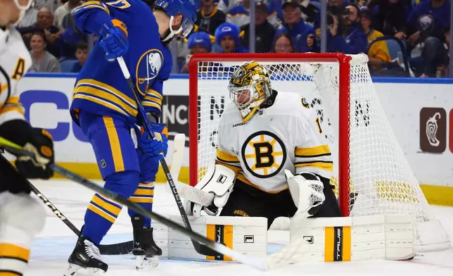 Boston Bruins goaltender Jeremy Swayman (1) stops a shot by Buffalo Sabres left wing Jason Zucker (17) during the first period in Game 5 of a first-round NHL hockey Stanley Cup playoff series Tuesday, April 28, 2026, in Buffalo, N.Y. (AP Photo/Jeffrey T. Barnes)