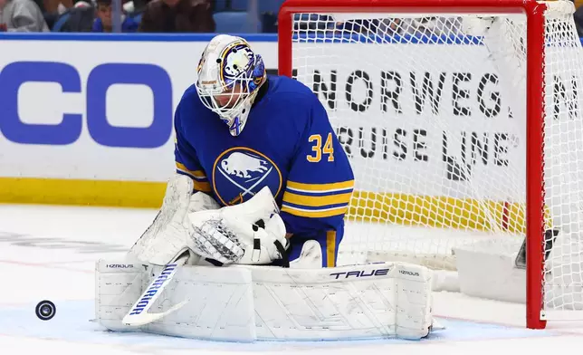 Buffalo Sabres goaltender Alex Lyon (34) makes a save during the second period in Game 5 of a first-round NHL hockey Stanley Cup playoff series against the Boston Bruins Tuesday, April 28, 2026, in Buffalo, N.Y. (AP Photo/Jeffrey T. Barnes)