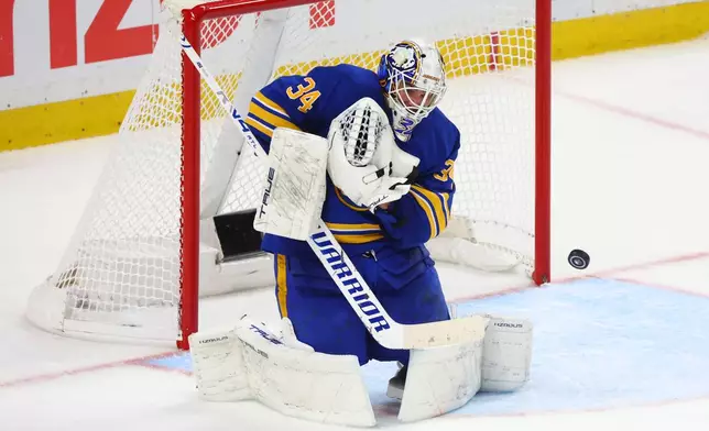 Buffalo Sabres goaltender Alex Lyon (34) makes a save during the third period in Game 5 of a first-round NHL hockey Stanley Cup playoff series against the Boston Bruins Tuesday, April 28, 2026, in Buffalo, N.Y. (AP Photo/Jeffrey T. Barnes)