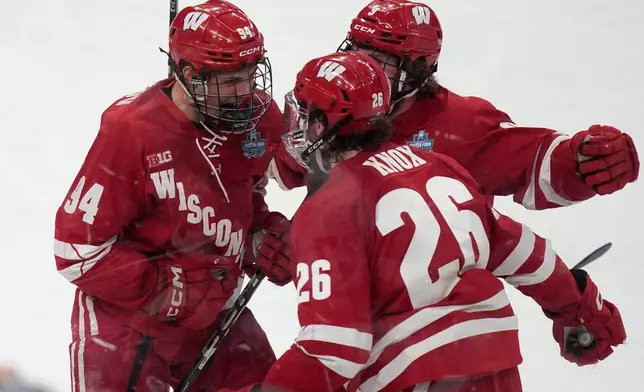 Wisconsin forward Vasily Zelenov, left, celebrates after scoring against Denver in the first period of the championship game at the NCAA Frozen Four men's college hockey tournament Saturday, April 11, 2026, in Las Vegas. (AP Photo/John Locher)