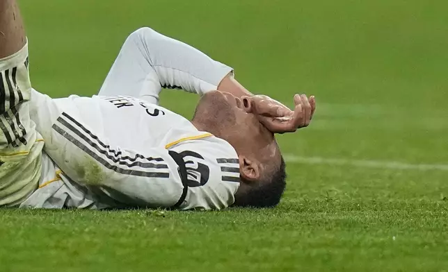 Real Madrid's Kylian Mbappe lies on the pitch after injuring during the Champions League quarterfinal second leg soccer match between Bayern Munich and Real Madrid in Munich, Germany, Wednesday, April 15, 2026. (AP Photo/Matthias Schrader)