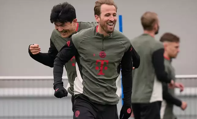 Bayern's Kim Min-jae and Bayern's Harry Kane exercise during a training session ahead of the Champions League quarterfinal second leg soccer match between Bayern Munich and Real Madrid in Munich, Germany, Tuesday, April 14, 2026. (AP Photo/Matthias Schrader)