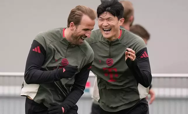 Bayern's Kim Min-jae and Bayern's Harry Kane having fun during a training session ahead of the Champions League quarterfinal second leg soccer match between Bayern Munich and Real Madrid in Munich, Germany, Tuesday, April 14, 2026. (AP Photo/Matthias Schrader)