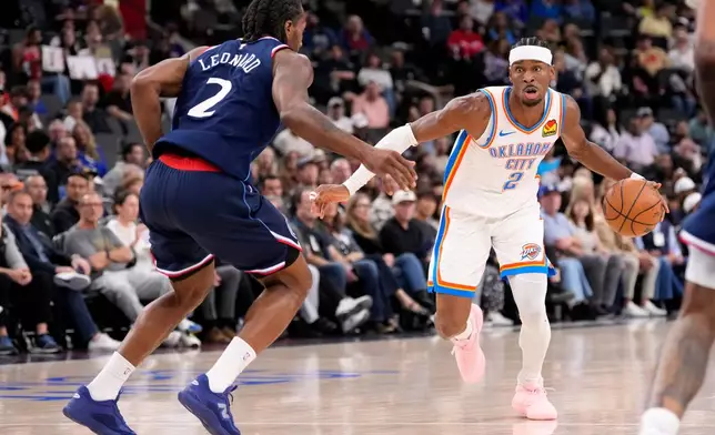Oklahoma City Thunder guard Shai Gilgeous-Alexander, right, tries to get past Los Angeles Clippers forward Kawhi Leonard during the first half of an NBA basketball game Wednesday, April 8, 2026, in Inglewood, Calif. (AP Photo/Mark J. Terrill)