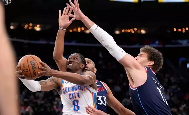 Oklahoma City Thunder guard Jalen Williams, left, shoots as Los Angeles Clippers forward Nicolas Batum, center, center Brook Lopez defend during the first half of an NBA basketball game Wednesday, April 8, 2026, in Inglewood, Calif. (AP Photo/Mark J. Terrill)