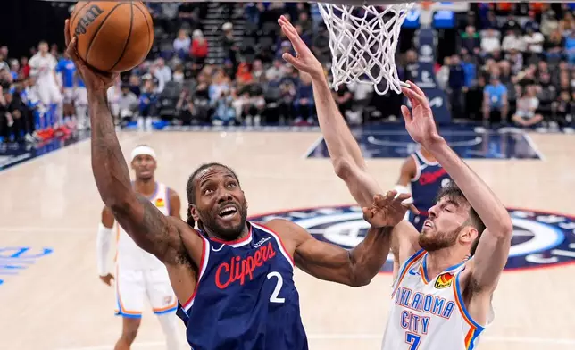 Los Angeles Clippers forward Kawhi Leonard, left, shoots as Oklahoma City Thunder center Chet Holmgren defends during the first half of an NBA basketball game Wednesday, April 8, 2026, in Inglewood, Calif. (AP Photo/Mark J. Terrill)