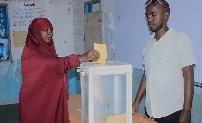 A woman casts her vote at a polling station during early voting in the presidential elections at Mouloud, in Djibouti, Friday, April 10, 2026. (AP Photo/Guirreh Moumin)