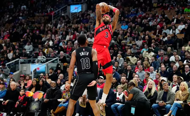 Toronto Raptors forward Brandon Ingram (3) goes up to shoot over Brooklyn Nets guard Malachi Smith (18) during first-half NBA basketball game action in Toronto, Sunday, April 12, 2026. (Frank Gunn/The Canadian Press via AP)