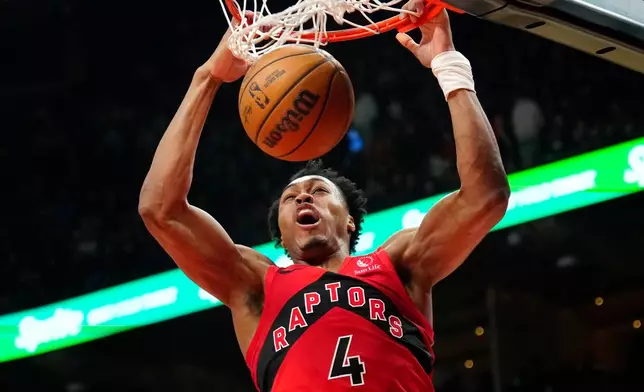 Toronto Raptors forward Scottie Barnes (4) slam dunks the ball during first half NBA basketball action against the Brooklyn Nets, in Toronto, Sunday, April 12, 2026. (Frank Gunn/The Canadian Press via AP)