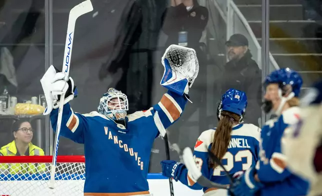Vancouver Goldeneyes goaltender Kristen Campbell (50) celebrates with Mellissa Channell-Watkins (23) after defeating the Montreal Victoire in a PWHL hockey game, in Vancouver, on Tuesday, April 21, 2026. (Ethan Cairns/The Canadian Press via AP)