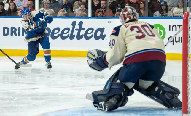 Vancouver Goldeneyes' Abby Boreen (22) shoots the puck as Montreal Victoire goaltender Sandra Abstreiter (30) watches during the third period of a PWHL hockey game, in Vancouver, on Tuesday, April 21, 2026. (Ethan Cairns/The Canadian Press via AP)