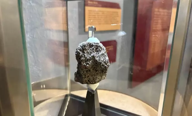 A moon rock collected by Apollo astronaut Harrison "Jack" Schmitt in 1972 is displayed at the New Mexico Museum of Natural History and Science in Albuquerque, N.M., on April 22, 2026. (AP Photo/Susan Montoya Bryan)